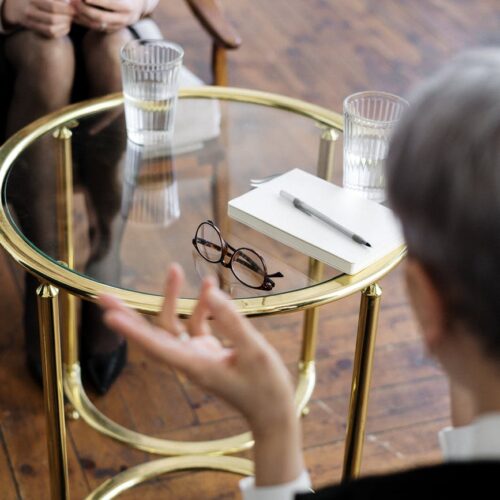 woman in black shirt sitting on chair