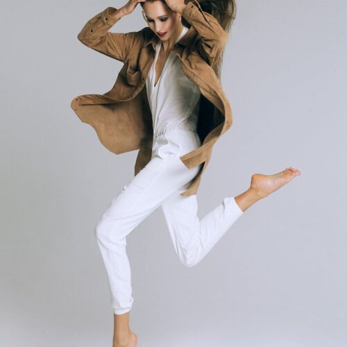 fashionable woman jumping on white background